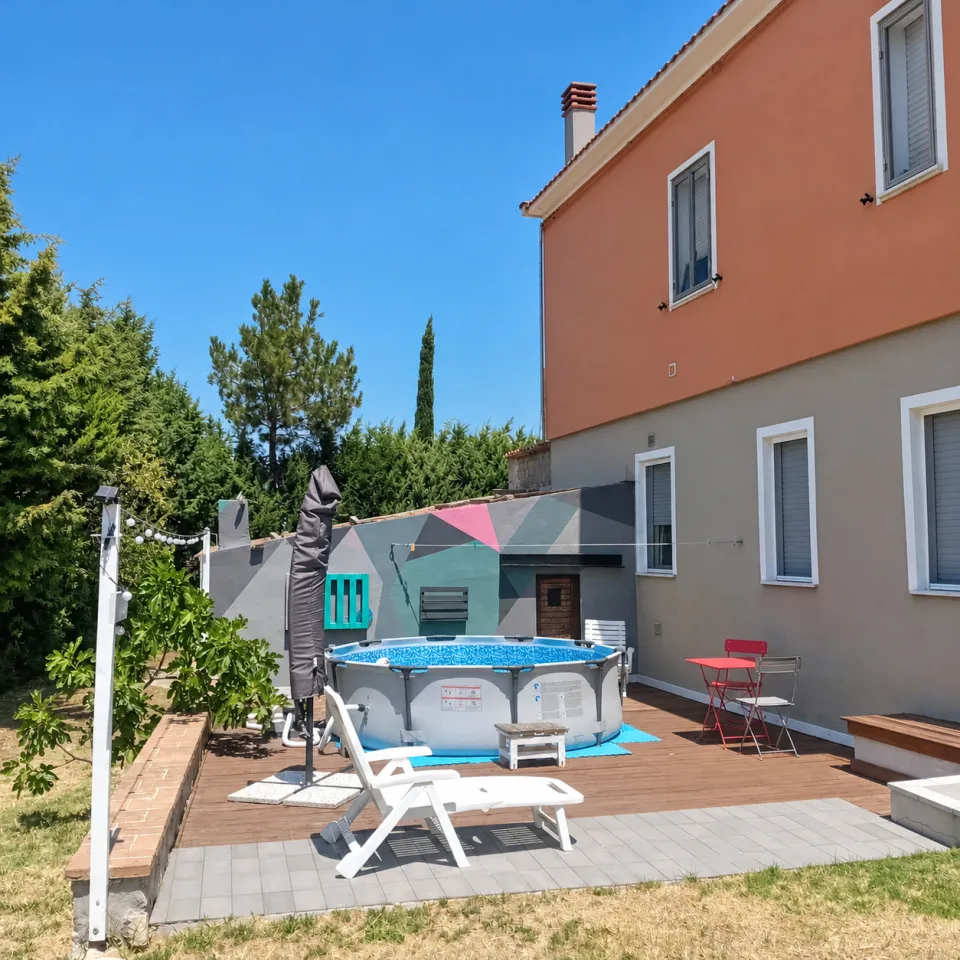 The small summer pool on the wooden deck, at the back of the house